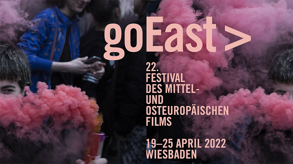 Das Plakat des goEast Festivals. Im Hintergrund sind kleine Farbpulverexplosionen zu sehen, die Teilweise Personen verstecken.