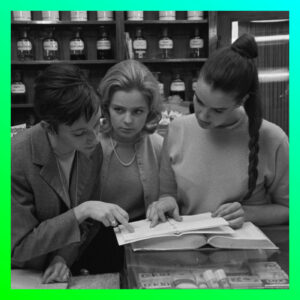 Drei Frauen Mitte der 1960 er Jahre in einer Apotheke über ein Buch gebeugt, neon-grüner Rahmen